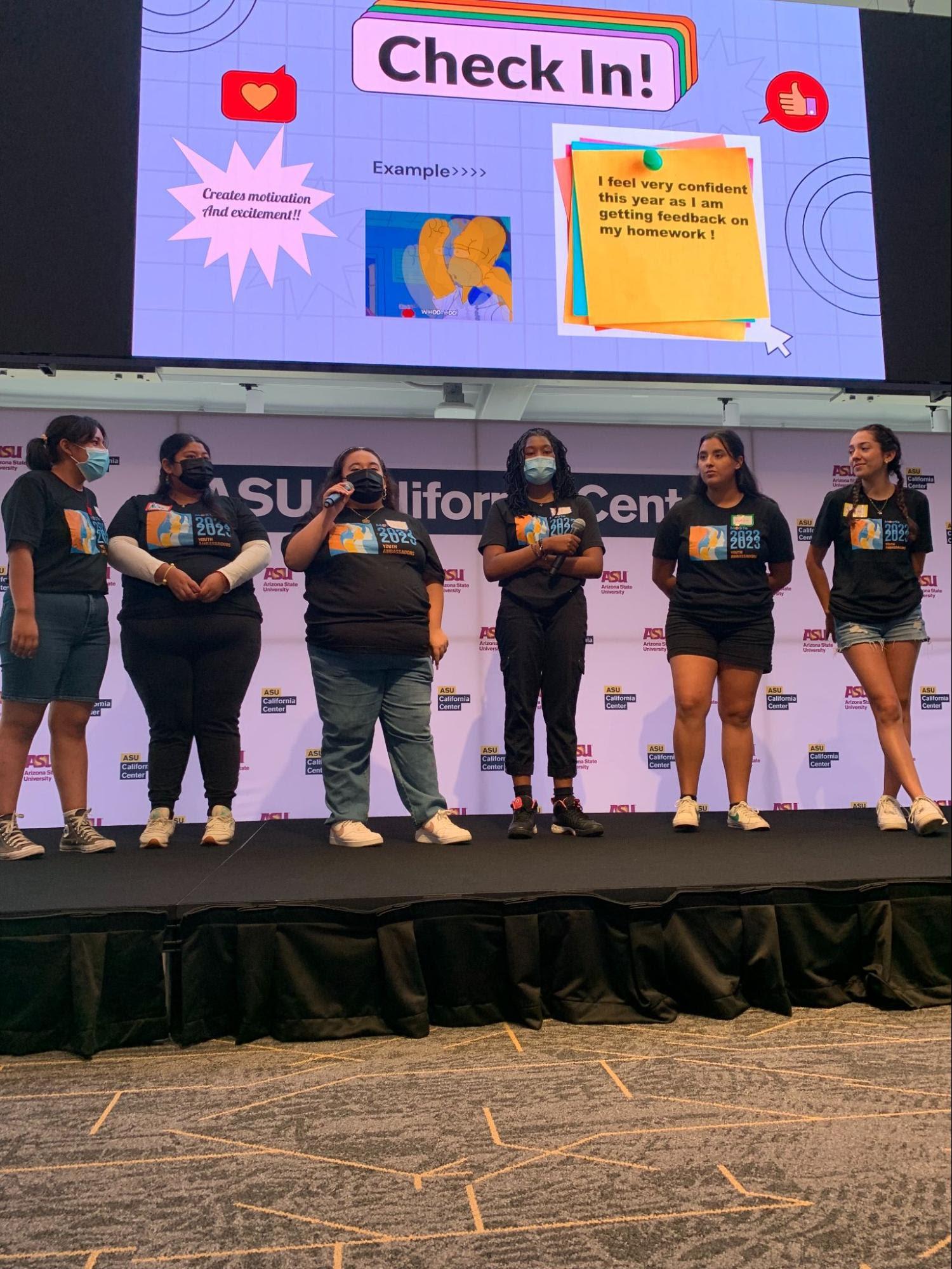 Young women in matching T-shirts on podium